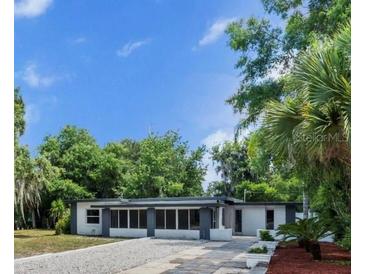 Charming single-story home featuring a clean facade, inviting entrance, and beautiful surrounding greenery at 120 E Wilt Ave, Eustis, FL 32726