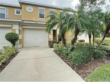 Charming two-story home with a well-manicured front yard and a spacious two-car garage at 13213 Daniels Landing Cir, Winter Garden, FL 34787