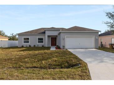 Charming single-story home with a well-maintained lawn, a two-car garage, and a classic design at 196 Anzio Dr, Kissimmee, FL 34758