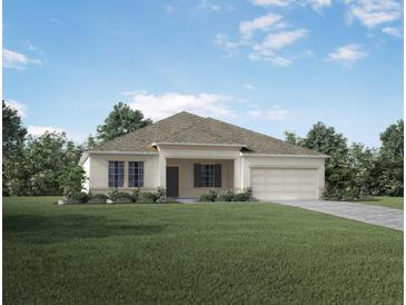 Charming single-story home with a well-manicured lawn and attached garage at 421 W Ariel Rd, Edgewater, FL 32141