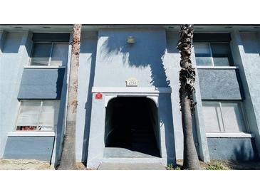 Building entrance featuring address with a covered entrance and dual palm trees at 4759 S Texas Ave # 4759C, Orlando, FL 32839