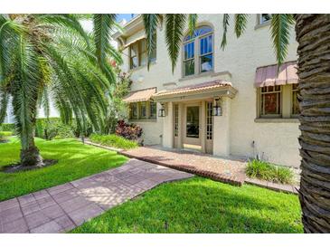 Charming home exterior with lush landscaping, a brick walkway, and a welcoming front entrance at 613 E Ridgewood St # 5, Orlando, FL 32803