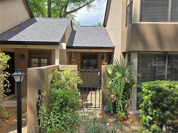 Inviting townhome featuring a gated entry and lush landscaping, creating curb appeal at 940 Douglas Ave # 132, Altamonte Springs, FL 32714