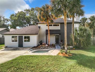 Beautifully landscaped front yard with a unique water feature adding a touch of elegance to the home's exterior at 1040 Waverly Dr, Longwood, FL 32750