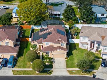 Beautiful two-story home with a screened-in pool area and a well-maintained lawn at 1243 Osprey Way, Apopka, FL 32712