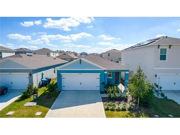 Charming single Gathering home featuring a two-car garage and manicured landscaping in a desirable neighborhood at 1260 Berry Ln, Davenport, FL 33837