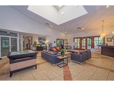 Inviting lobby area with comfortable seating, tiled floors, and plenty of natural light from the overhead skylight at 3021 Red Ginger Rd, Kissimmee, FL 34747