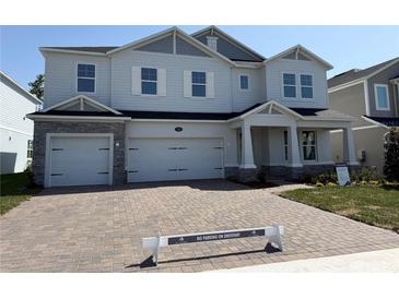 Beautiful two-story home with a brick driveway and three-car garage, offering plenty of space and curb appeal at 780 Pointe Emerson Blvd, Apopka, FL 32703