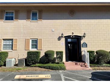 Well maintained condominium exterior with garden area, reserved parking, and secure entrance at 1100 E Caroline St # 119, Tavares, FL 32778