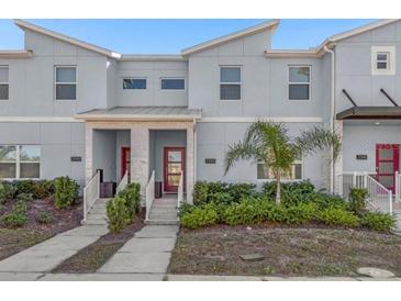 Inviting townhome showcases a contemporary architectural style with well-maintained landscaping at 2945 Simile St, Kissimmee, FL 34746