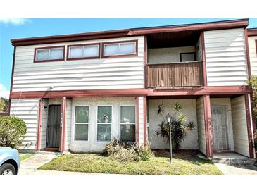 Charming townhome featuring a cozy balcony, well-maintained landscaping, and a welcoming entrance at 4001 Dolomite St # Ge, Orlando, FL 32839