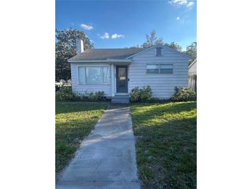 Charming single-story home with a well-maintained front yard and inviting walkway at 48 E Par St, Orlando, FL 32804