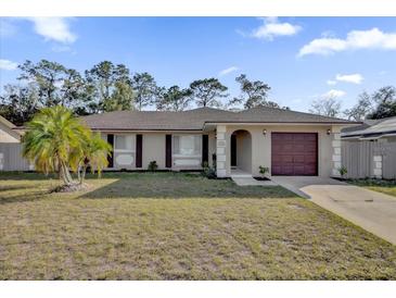 Charming single-story home with a well-manicured front yard, mature landscaping, and a one-car garage at 4804 Beacon St, Orlando, FL 32808