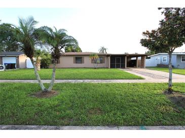 Charming single-story home featuring a well-maintained lawn, mature trees, and a covered front entry at 7119 Leighton Way, Orlando, FL 32822