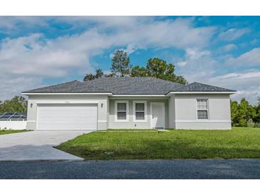 Charming single-story home with a well-manicured lawn and a two-car garage at 773 Marion Oaks Pass, Ocala, FL 34473