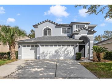 Charming two-story home with a three-car garage and well-manicured landscaping at 1024 Harbor Hill St, Winter Garden, FL 34787