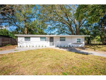 Charming single-story home with a fresh white painted brick and inviting landscaping in the front yard at 103 Ford Ave, Altamonte Springs, FL 32701