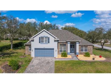 Desirable single-Gathering home with gray paint, well-kept lawn, and elegant landscaping at 3978 Old Dunn Rd, Apopka, FL 32712