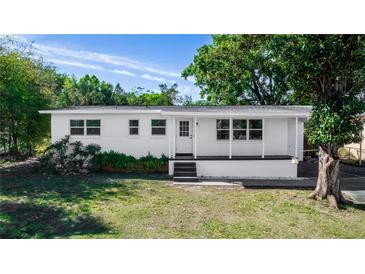 Charming single-story home with a well-maintained lawn and a welcoming front porch, painted in a bright, neutral color at 5508 Meridian Way, Orlando, FL 32808