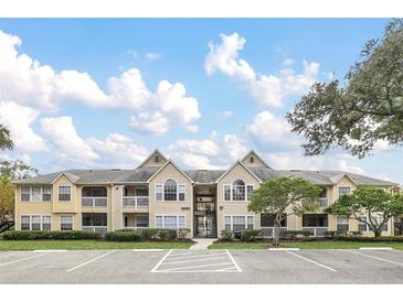 Inviting multi-Gathering home with yellow siding, and well maintained landscaping and ample parking space at 1043 S Hiawassee Rd # 3125, Orlando, FL 32835