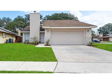 Charming home featuring a manicured lawn, driveway, and welcoming facade at 1188 La Mesa Ave, Winter Springs, FL 32708