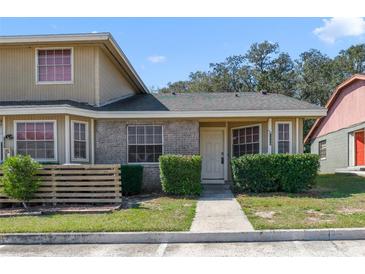 Charming townhome featuring a well-manicured lawn and inviting front entrance at 1248 Woodman Way, Orlando, FL 32818