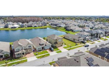 Beautiful aerial view of a lakeside community with well-maintained homes and lush green lawns at 2687 Chantilly Ave, Kissimmee, FL 34741