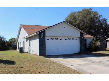 Single Gathering home featuring an attached two car garage and a traditional style roof at 274 W 20Th St, Apopka, FL 32703