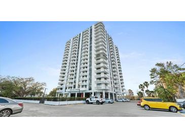 Upscale condo building featuring multiple floors, balconies, and street parking for residents and guests at 400 E Colonial Dr # 1607, Orlando, FL 32803