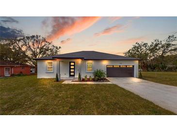 Charming single-story home with manicured lawn, fresh landscaping, and a two-car garage at 400 Miami Way, Poinciana, FL 34759