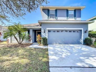 Charming two-story home featuring a well-maintained front yard and a two car garage at 4012 Longworth Loop, Kissimmee, FL 34744