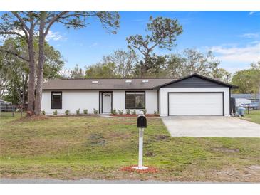 Charming single-story home featuring a freshly painted exterior, new landscaping and attached two-car garage at 4870 Oriole Dr, St Cloud, FL 34772