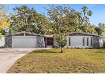 Charming single-story home with a well-manicured front lawn and welcoming curb appeal at 1407 Dunsany Ave, Orlando, FL 32806
