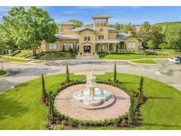 Beautiful community center with fountain, landscaping, and elegant architecture at 142 Villa Di Este Ter # 204, Lake Mary, FL 32746