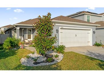 Charming single-story home with a well-maintained lawn and two-car garage, displaying great curb appeal at 2234 Bluebird Pl, St Cloud, FL 34771