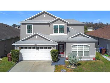 Charming two-story home with well-maintained landscaping and a two car garage at 2263 Mallard Creek Cir, Kissimmee, FL 34743