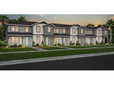 A row of newly built townhomes with neat lawns, sidewalks, and similar exterior finishes at 6736 Reverie Park Ave, Orlando, FL 32829