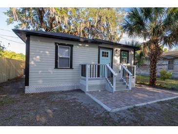 Charming home featuring a light blue front door and a brick entryway at 812 S Locust Ave, Sanford, FL 32771