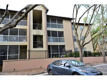 Exterior view of condo building with screened balconies and neatly manicured landscaping at 974 Leeward Pl # 205, Altamonte Springs, FL 32714