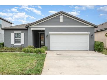 Charming single-story home with well-maintained lawn and two-car garage at 2032 Buckhanon Trl, Deland, FL 32720