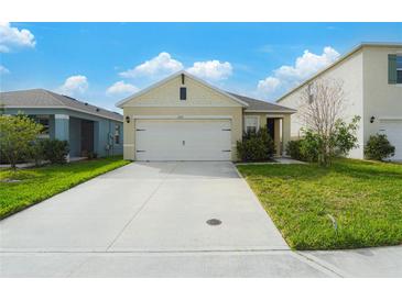 Charming single-Gathering home featuring a two-car garage and well-maintained front lawn at 2321 Tay Wes Dr, St Cloud, FL 34771