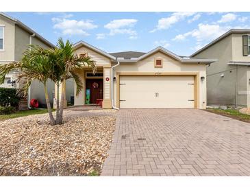 Charming single-story home featuring a two-car garage and a well-maintained front yard with stone landscaping at 2797 Monticello Way, Kissimmee, FL 34741