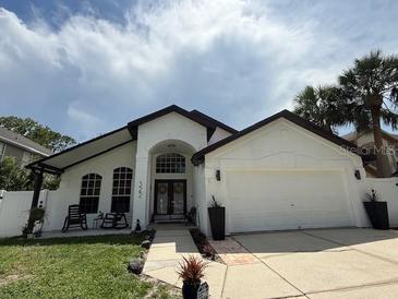 Well-maintained single-Gathering home featuring a 2-car garage and a beautifully landscaped front yard at 322 N Shadowbay Blvd, Longwood, FL 32779