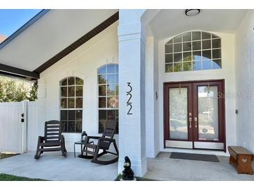 Welcoming front porch with seating and natural light, highlighting the home's entrance and curb appeal at 322 N Shadowbay Blvd, Longwood, FL 32779