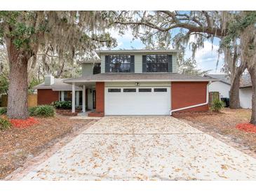 Charming two-story home featuring a red brick facade and a two-car garage at 4309 Enright Ct, Winter Park, FL 32792