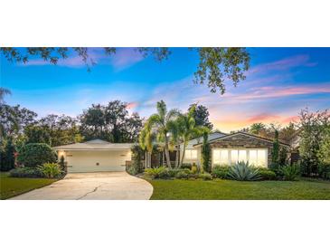 Charming home with a well-manicured lawn, lush landscaping, and a welcoming two-car garage at 533 Balmoral Rd, Winter Park, FL 32789