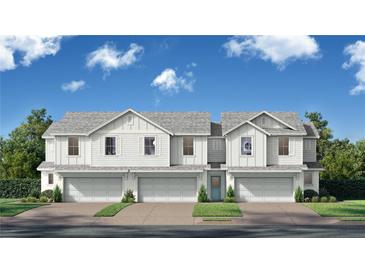 Charming new construction townhomes featuring bright exteriors, two-car garages and craftsman-style architecture at 6689 Horseshoe Lane Way, St Cloud, FL 34773