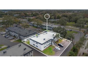 An aerial view of the multi-Gathering building showing the parking and surrounding landscape at 7636 Forest City Rd # F/70, Orlando, FL 32810