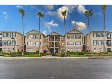 A charming condo building with well-maintained landscaping and beautiful palm trees at 8168 Boat Hook Loop # 707, Windermere, FL 34786