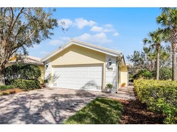 Charming home with a paved driveway, well-maintained landscaping, and a two-car garage at 11716 Astilbe Dr, Orlando, FL 32827